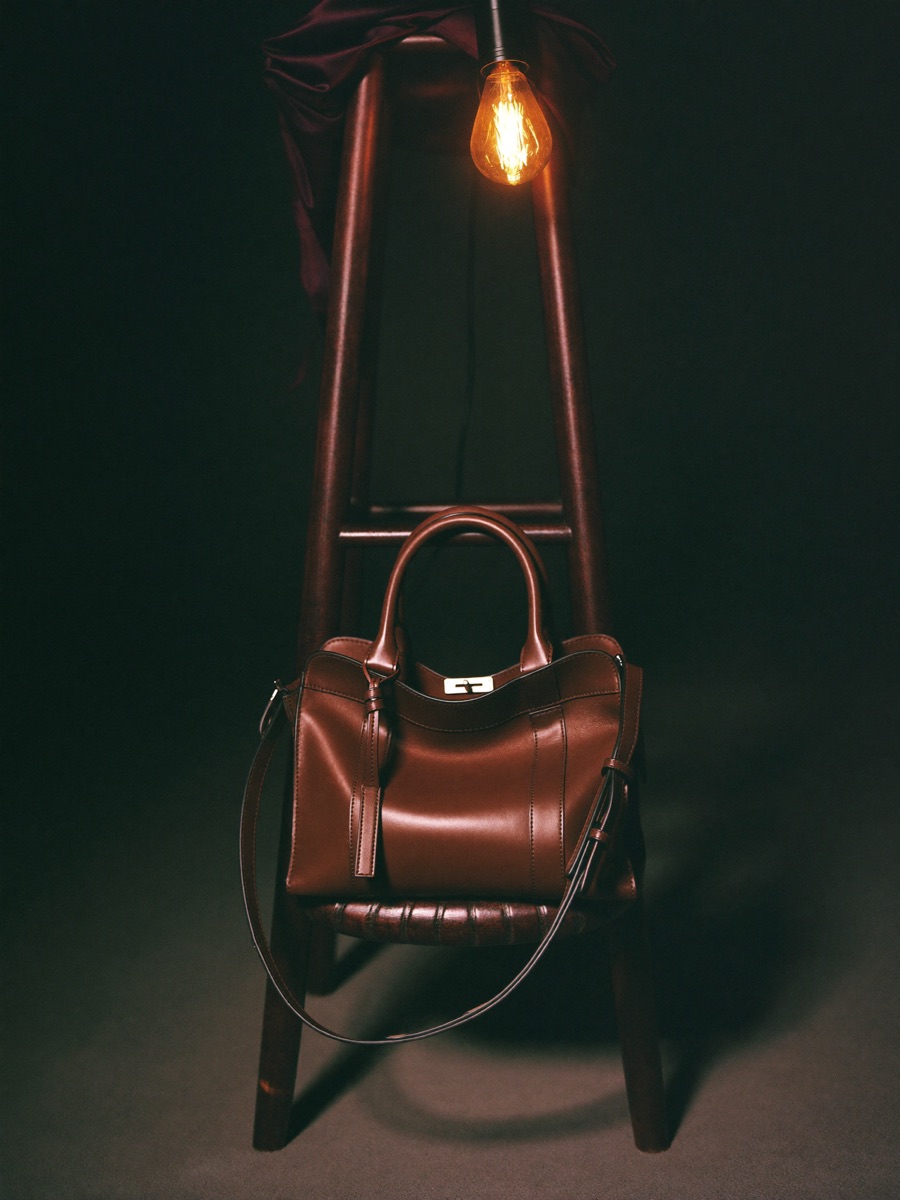 AI-generated leather handbag still life in warm studio lighting